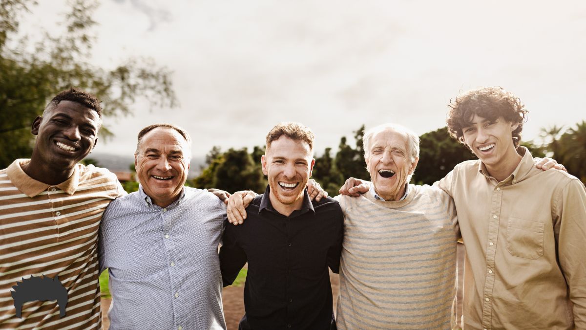 A group of men smiling after a group coaching session.