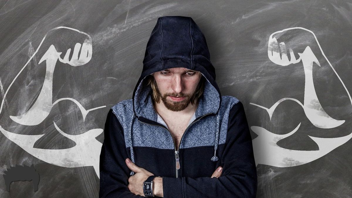 Man wearing a hoodie ready to be strong.