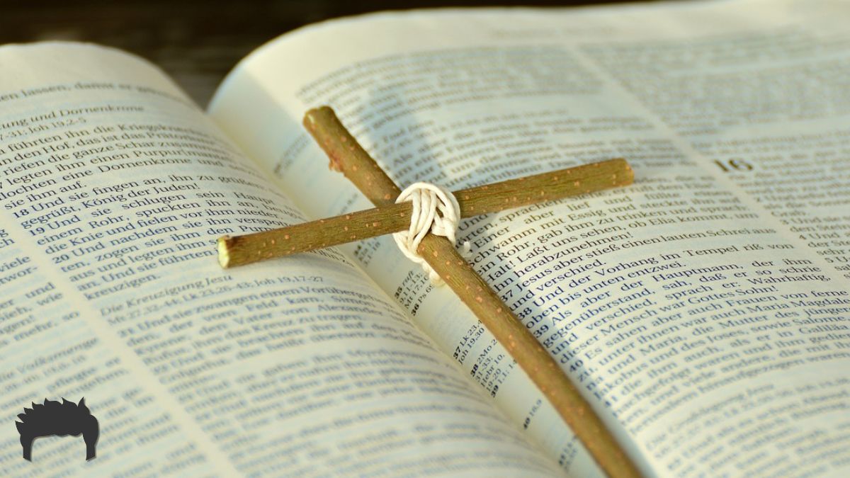 An open Bible with a wooden cross. 