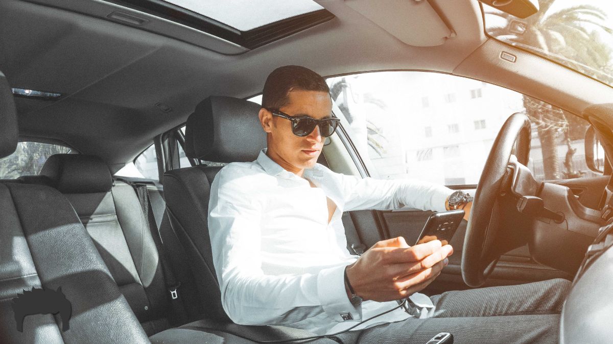 Man in his car on his cell phone.