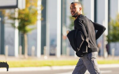 A man walking down the street in a hurry.