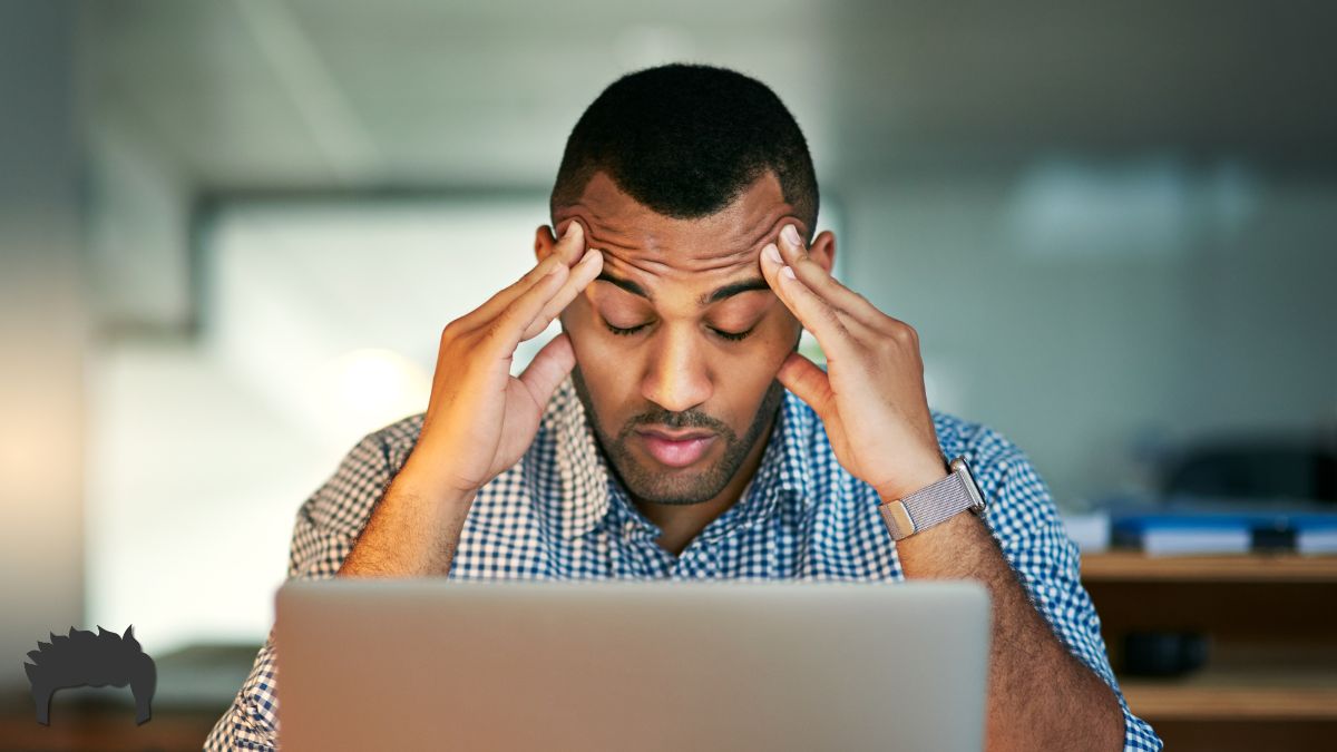 Man sitting at the computer feeling burned out.