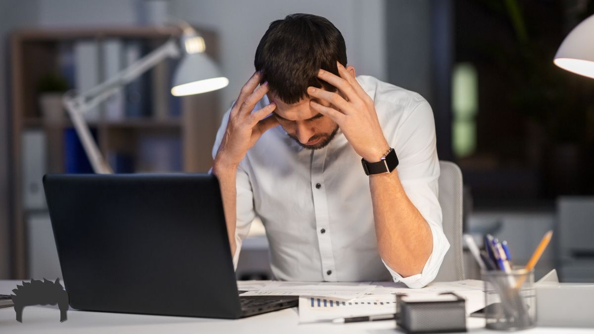 Man on his computer, frustrated with email overload.