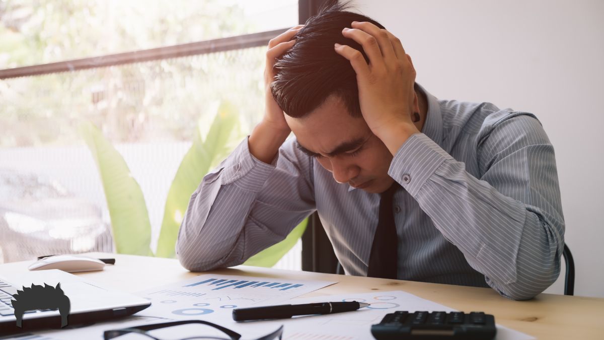 A man sitting at his desk, overworked.